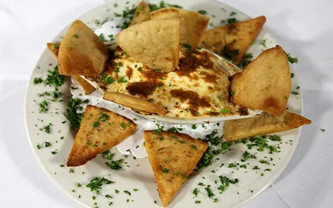 A warm appetizer served with toasted bread.