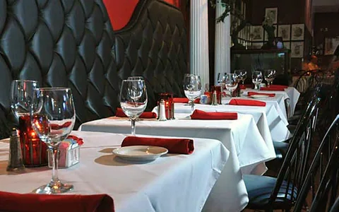 White tablecloths and red napkins in the dining room.