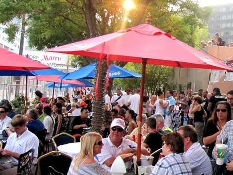 Guests under red umbrellas outside Luna Del Sea.