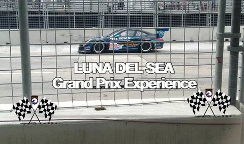 Race car passing a grandstand in the Luna Grand Prix album.